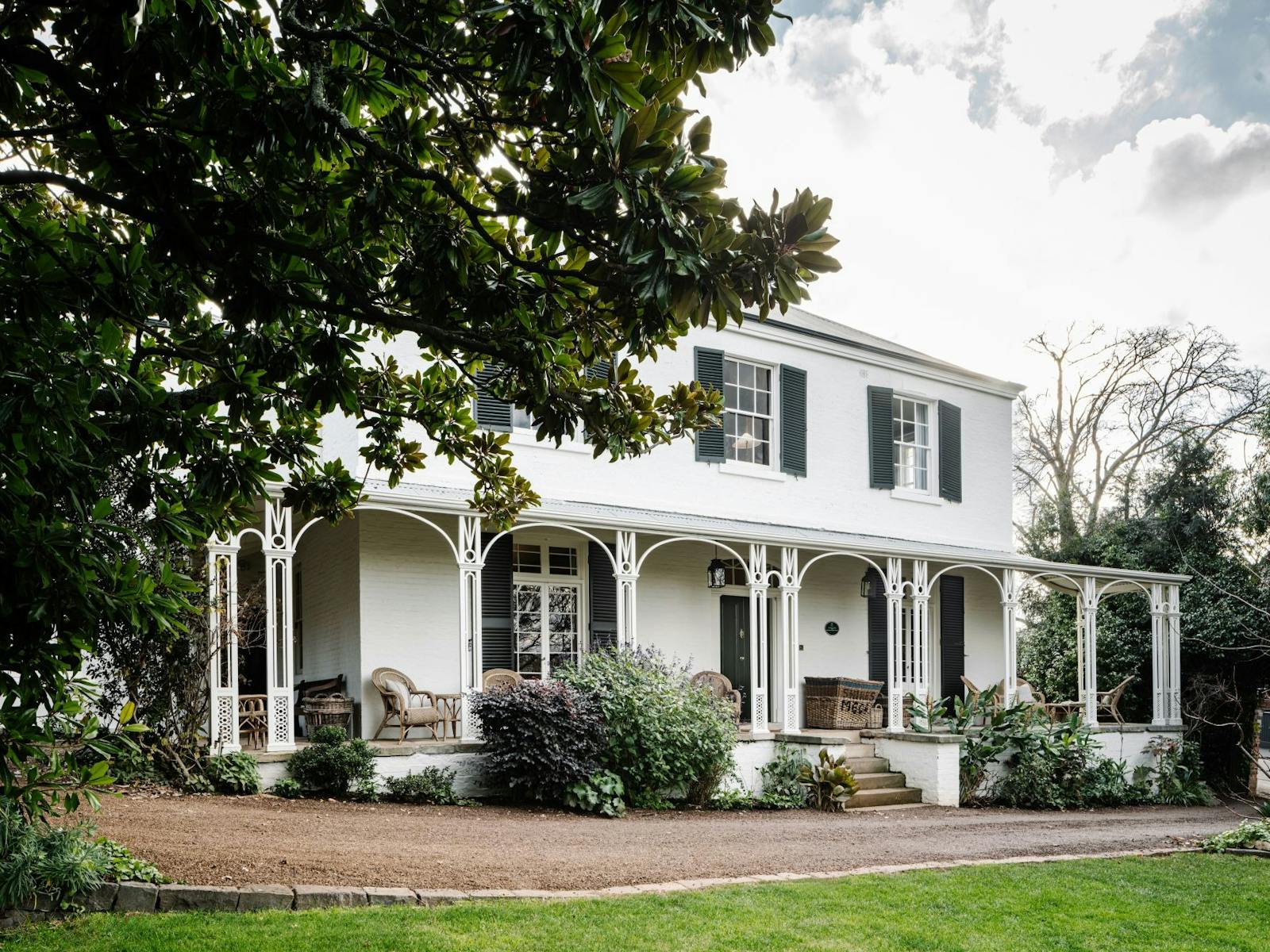 A Georgian house with two stories amongst lush and private gardens.