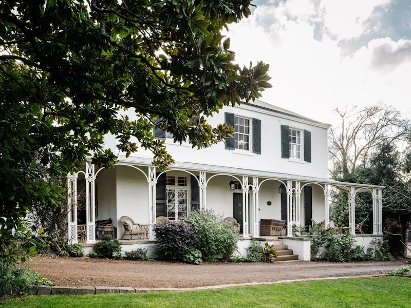 A Georgian house with two stories amongst lush and private gardens.