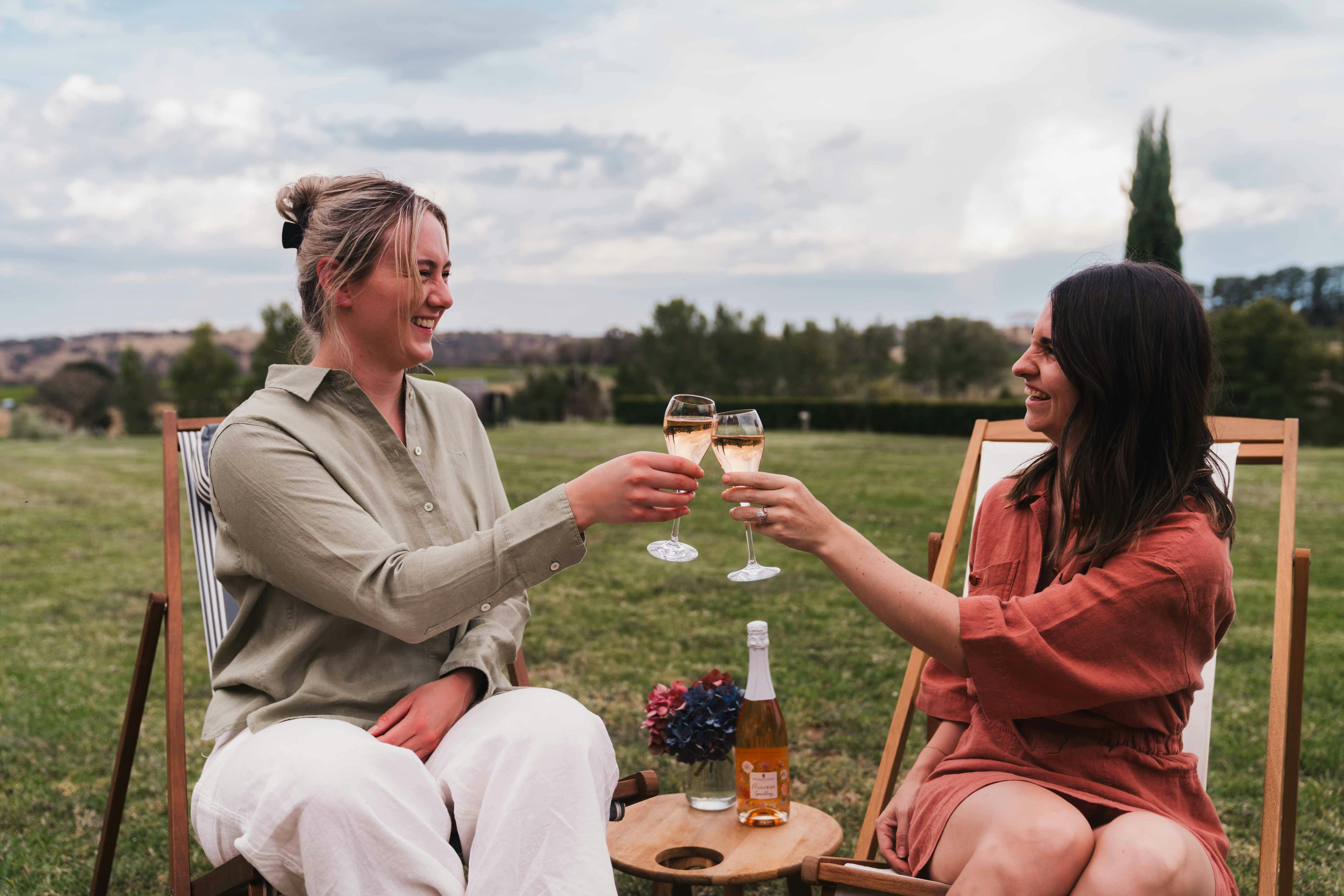 girls cheers wine on lawns at Stockmans Ridge Wines