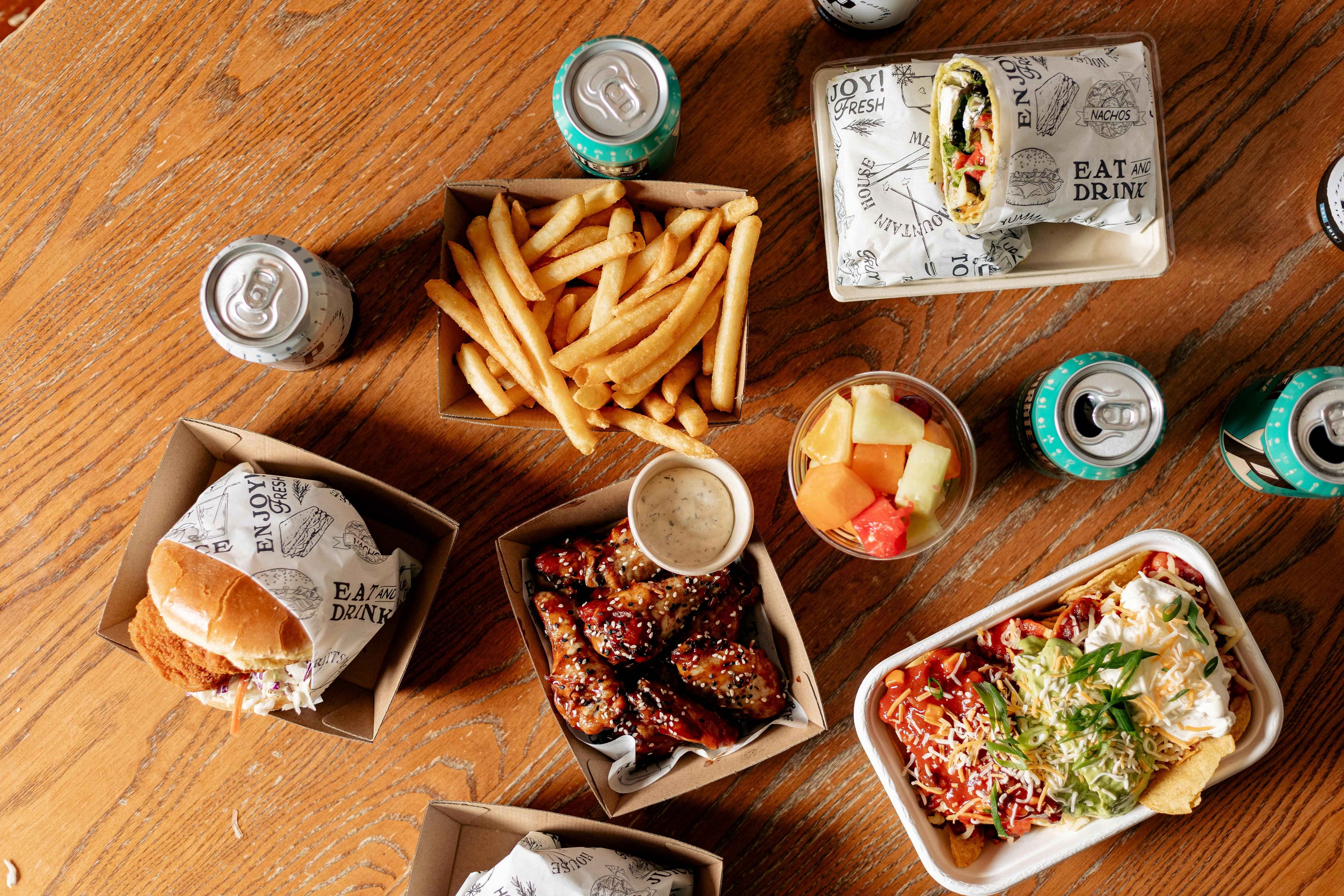 burger, fries, salad and other delicious food items on table