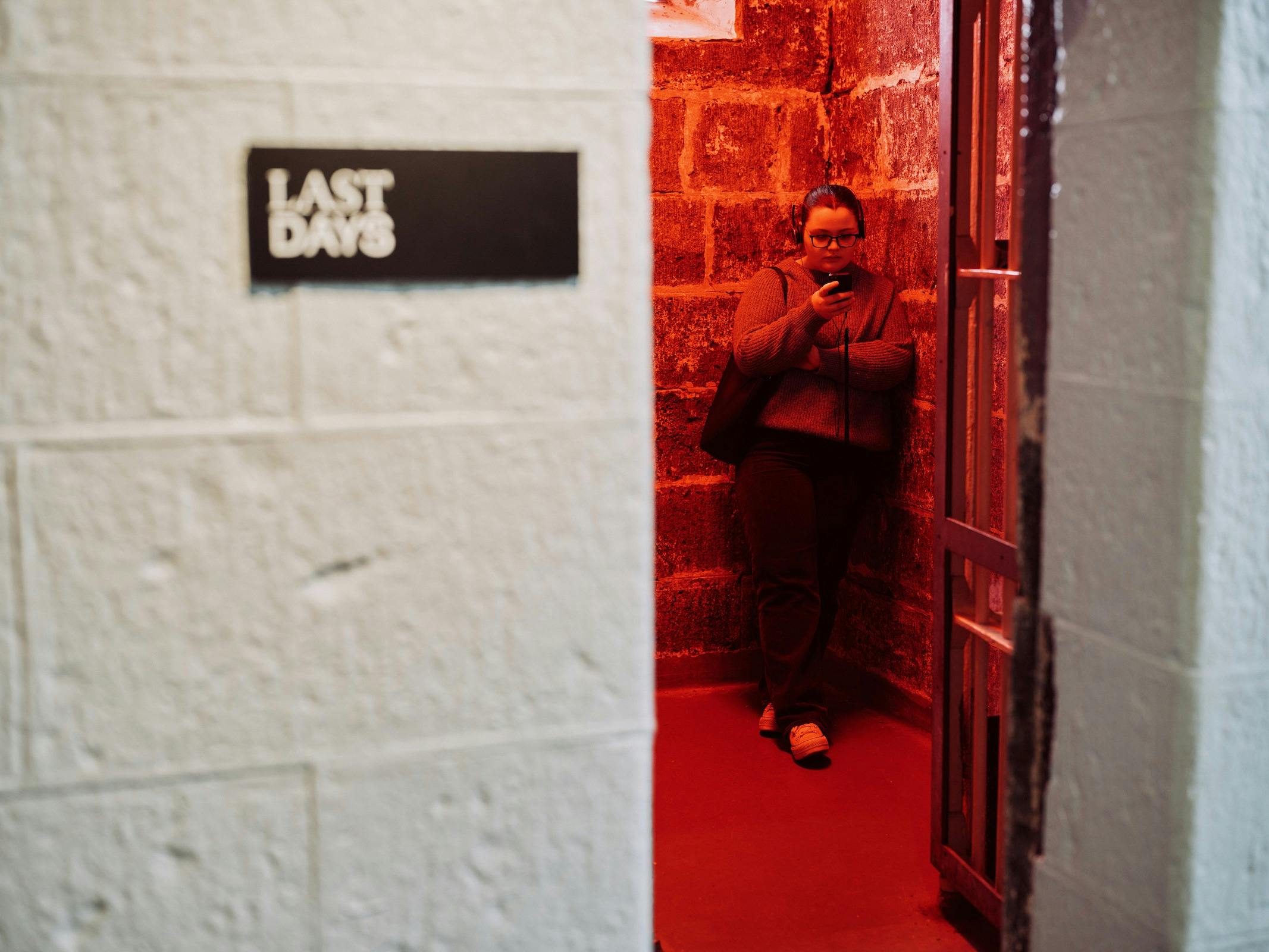 One person standing in dark cell