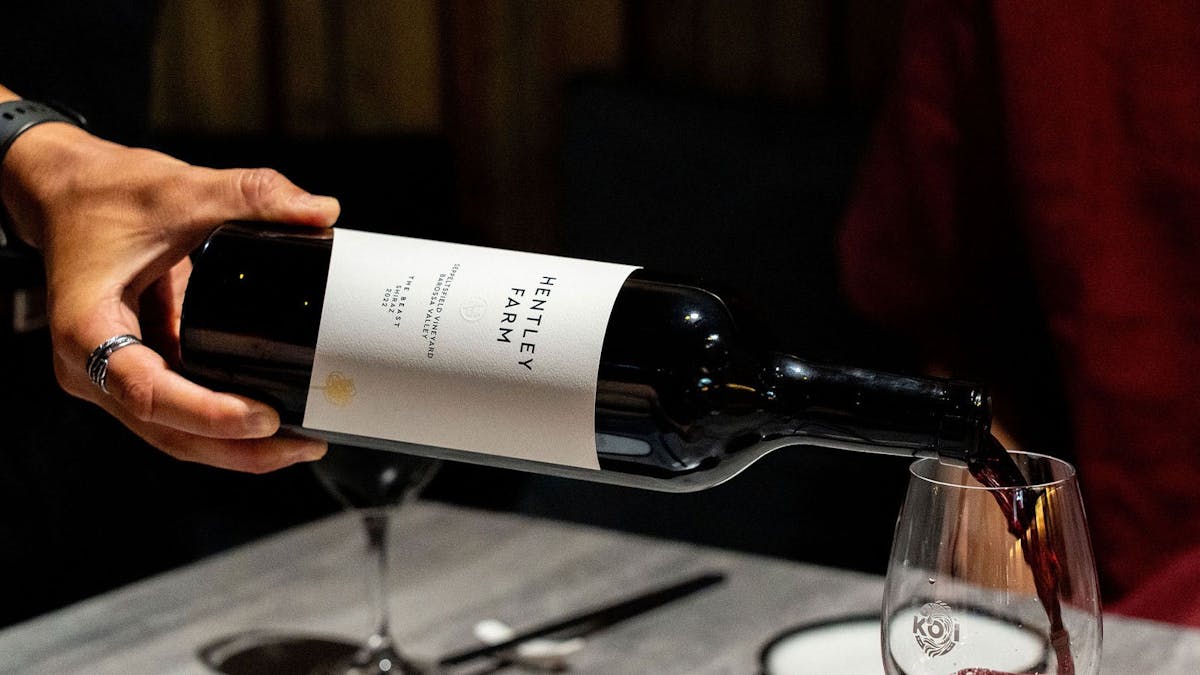 KOI BAr & Restaurant team member pouring a glass of Hently Farm The Beast wine.