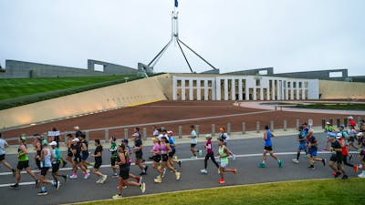 Participants running past New Parliament House