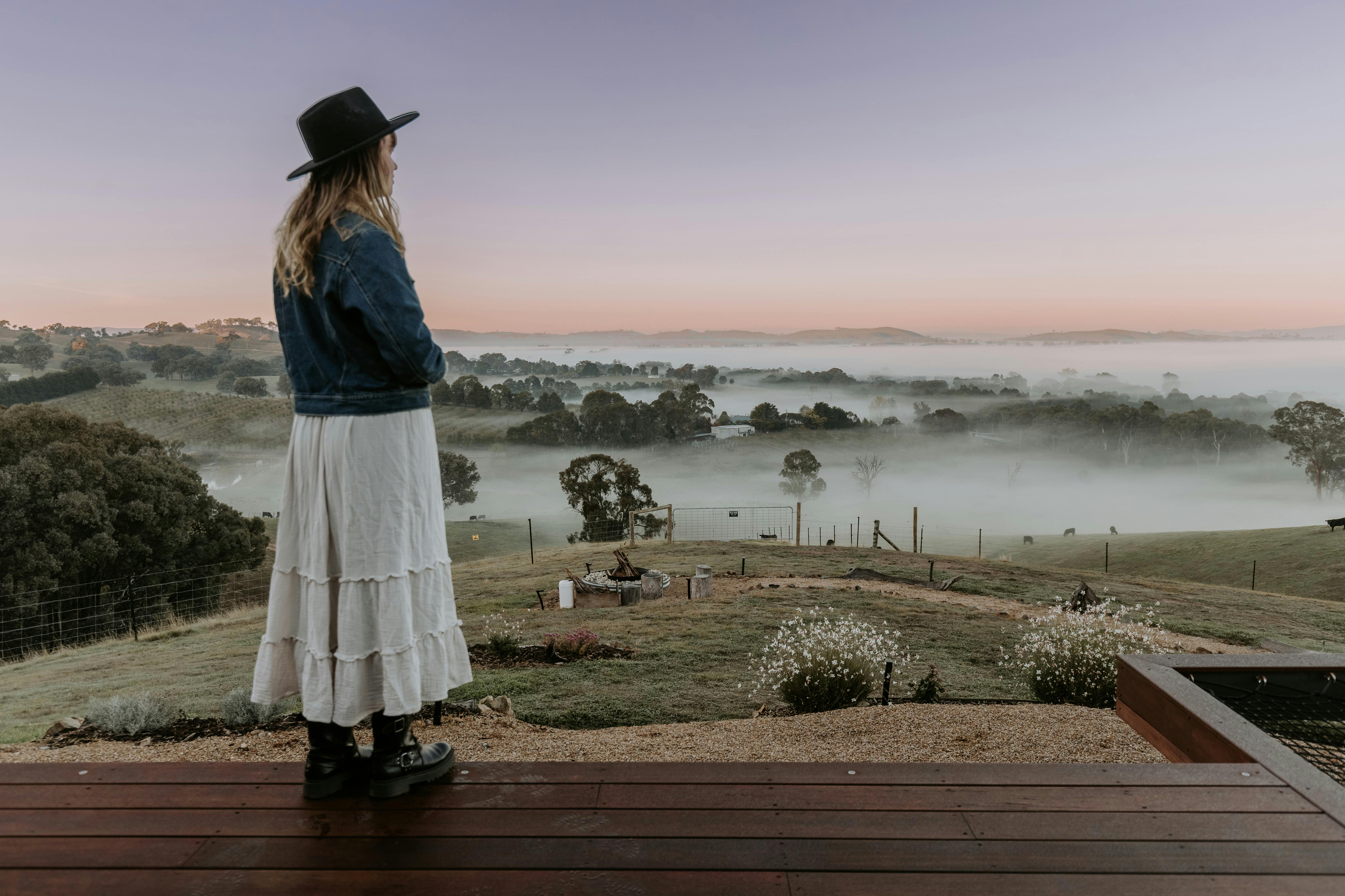 woman viewing epic view with fog coming through the valley at dawn