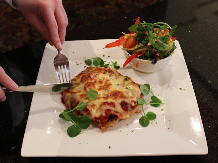 Chicken Parmigiana served with side salad or medley of vegetables