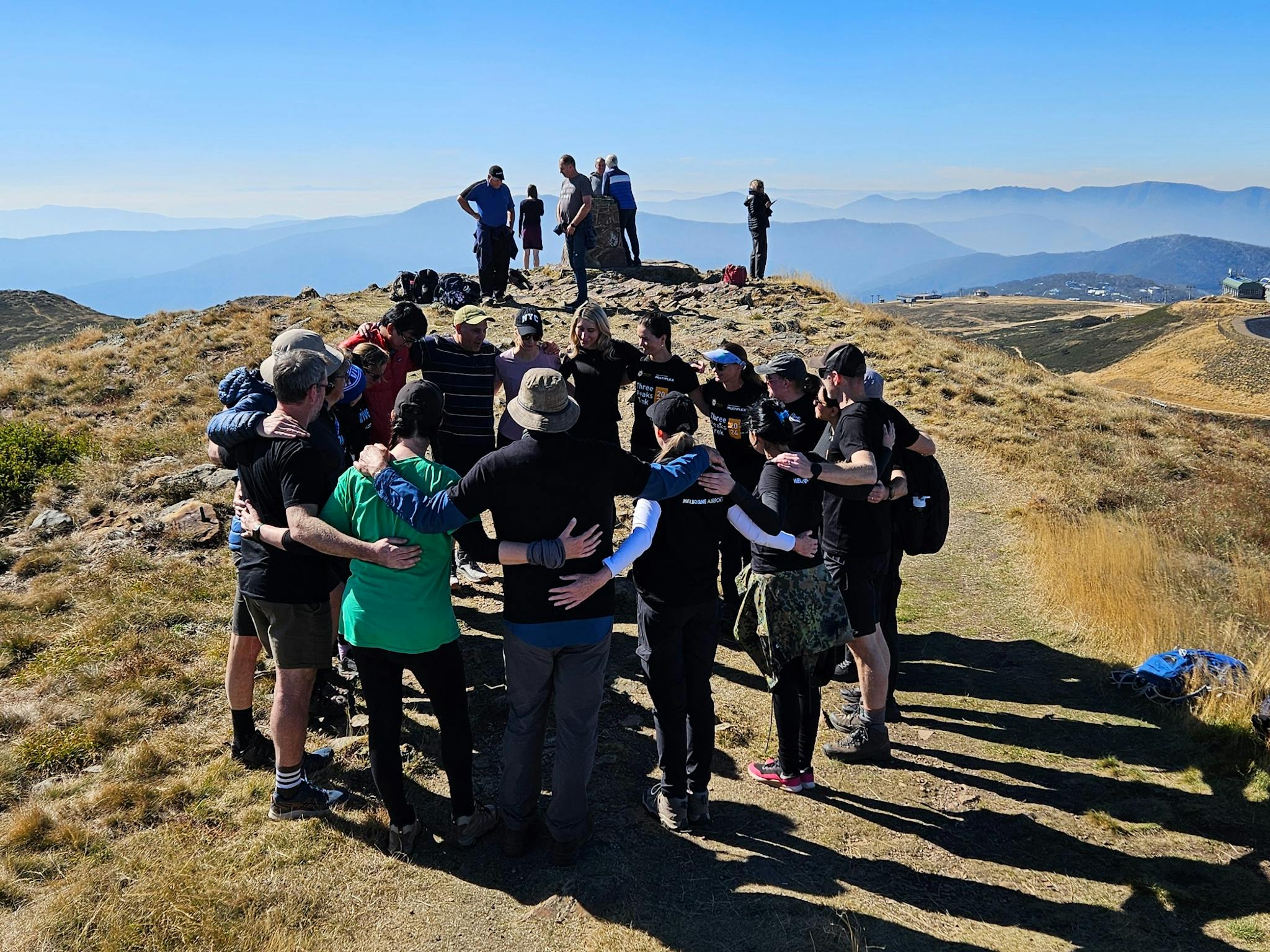 Hikers celebrating the last summit on a three day hike on top of Mt Buller.