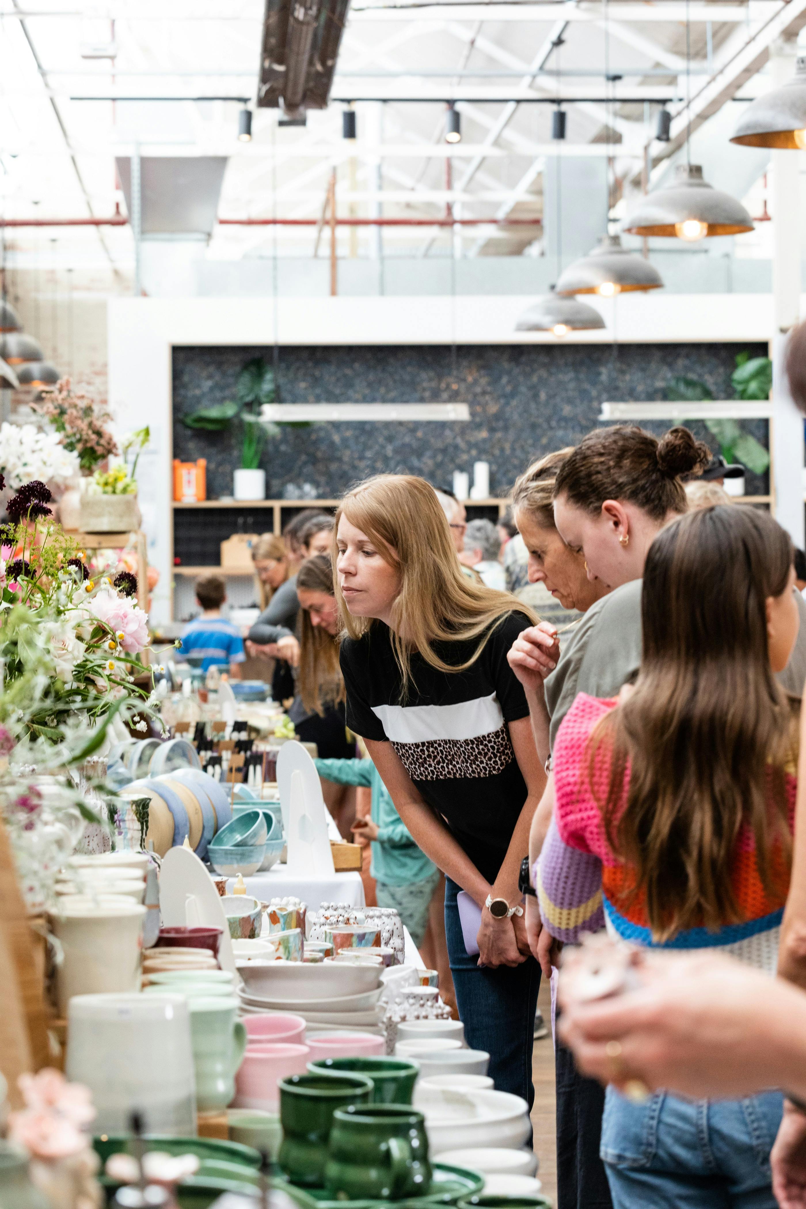 Crowds browsing handmade ceramics at the Geelong Ceramics Market inside Furphy Hall
