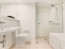 Guest bathroom with both shower and a comfy bathtub