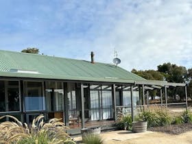 Exterior of The Cape Jaffa Wines Cottage surrounded by native plants, offering vineyard views and o