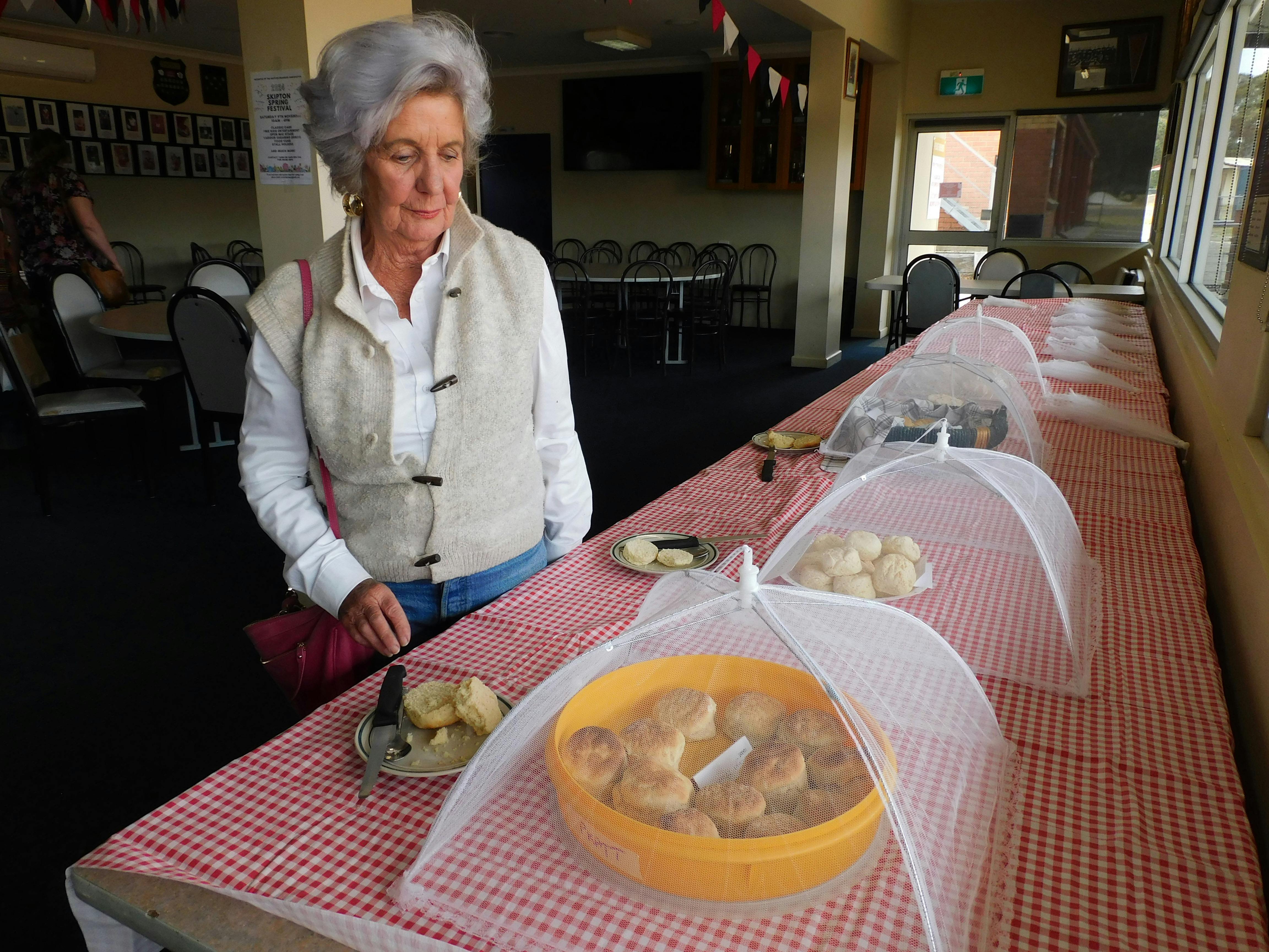 Judge standing beside a table of scones