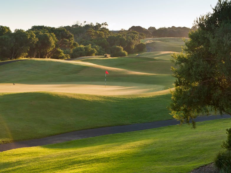 red flag in the centre of a golf course