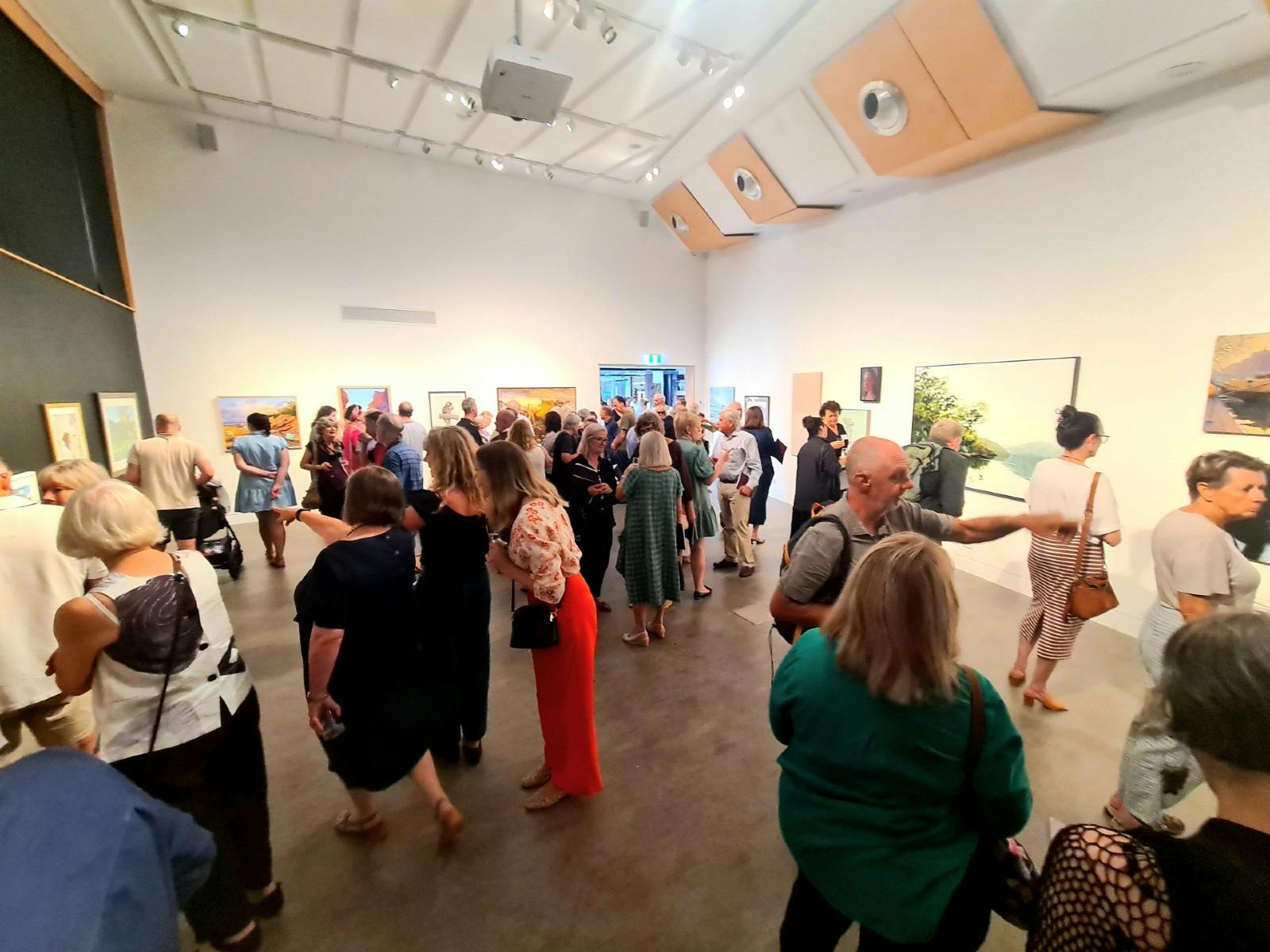 A large group of people in a gallery.