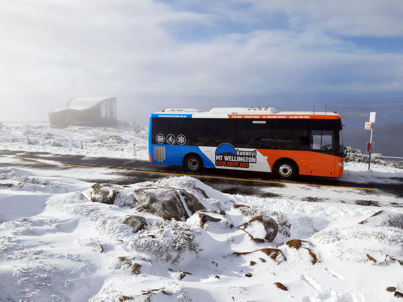 Bus parked in the snow  at the top of kunanyi/Mt Wellington.