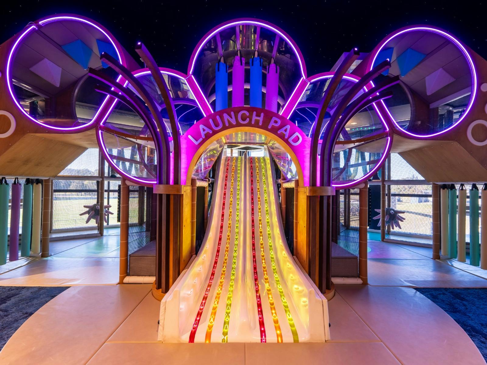 Photo of Brothers kids room featuring the slide and neon lights Photo of Brothers kids room featuring the slide and neon lights