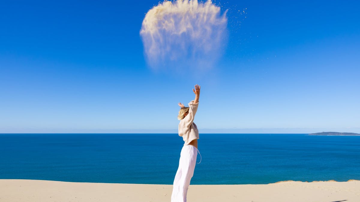 A lady at Carlo Sandblow throwing sand in the area