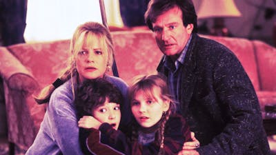 A family of four looking past the camera, huddling together scared