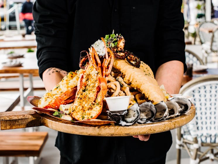 Seafood platter carried by waiter