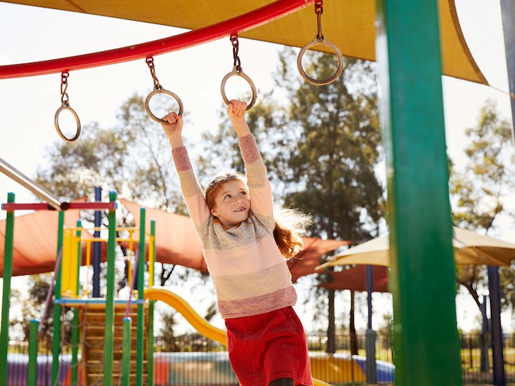 Child swinging on playground