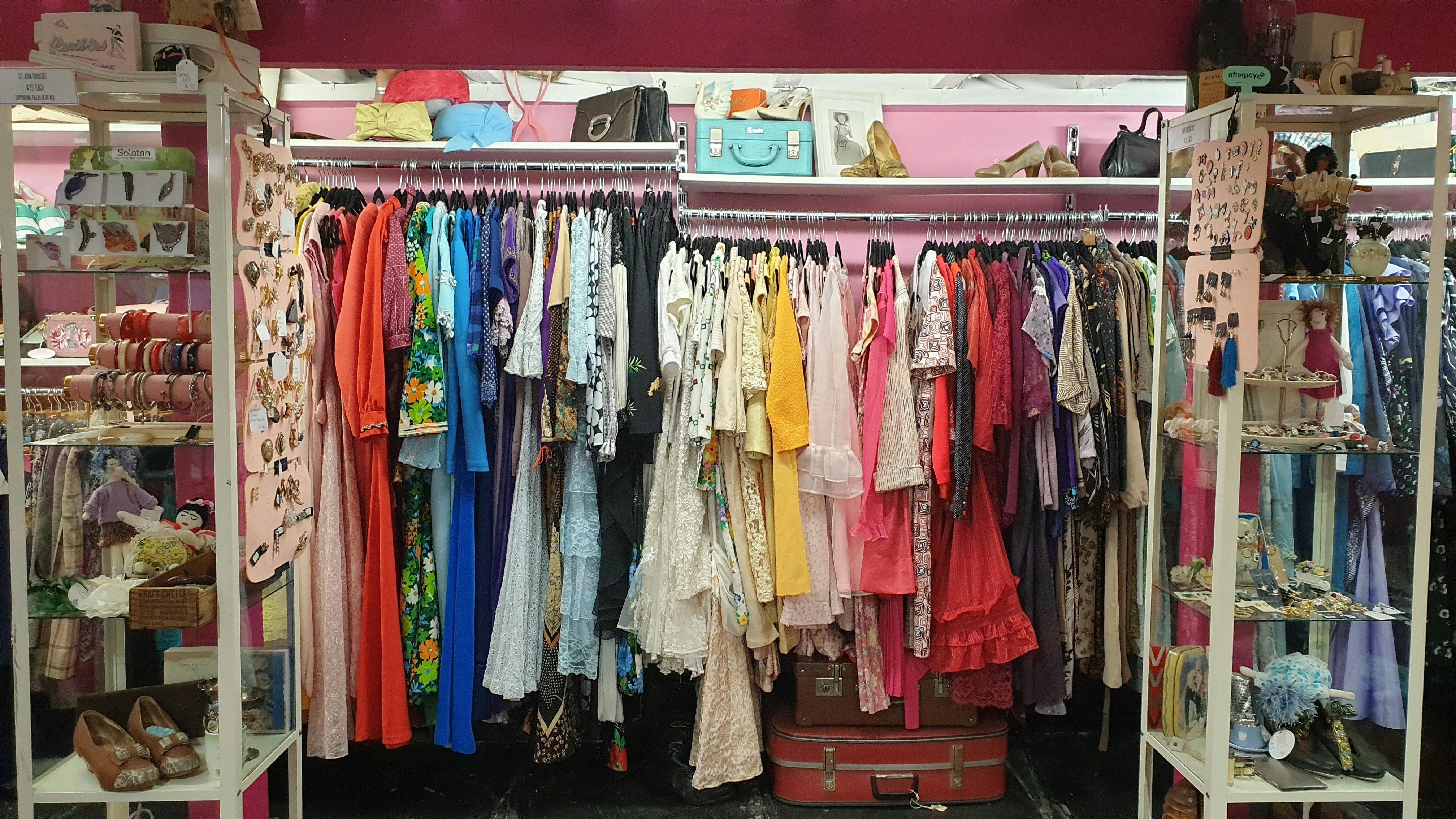 A clothes rack features a wide range of dresses in different lengths and colours.