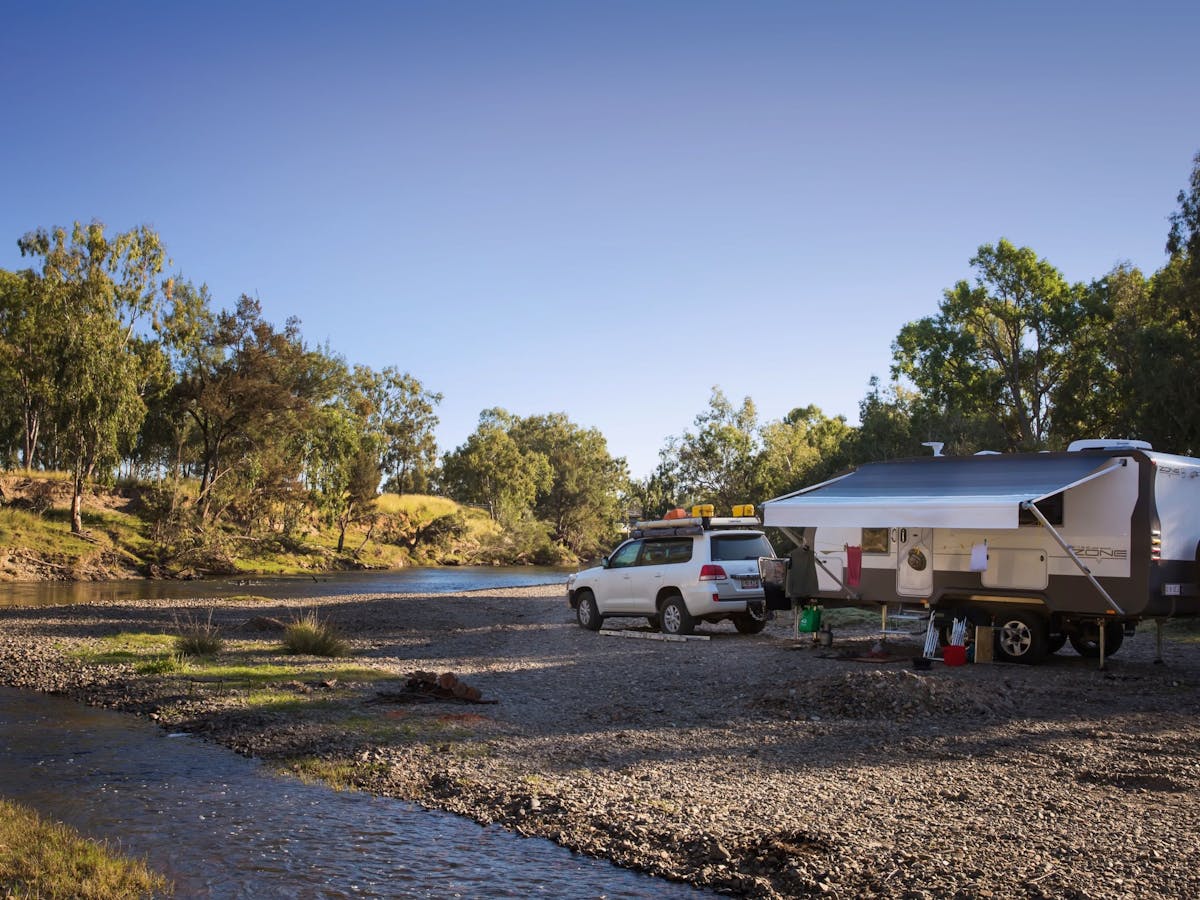 Caravan parked by the banks of the Dumeresq River