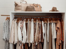Clothing rack in neutral colours with bags