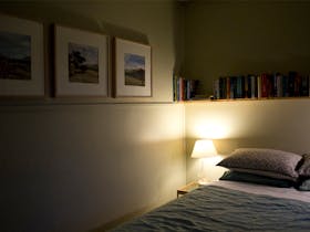 Peaceful and cozy at bedtime with soft lamp light and plenty of books to browse