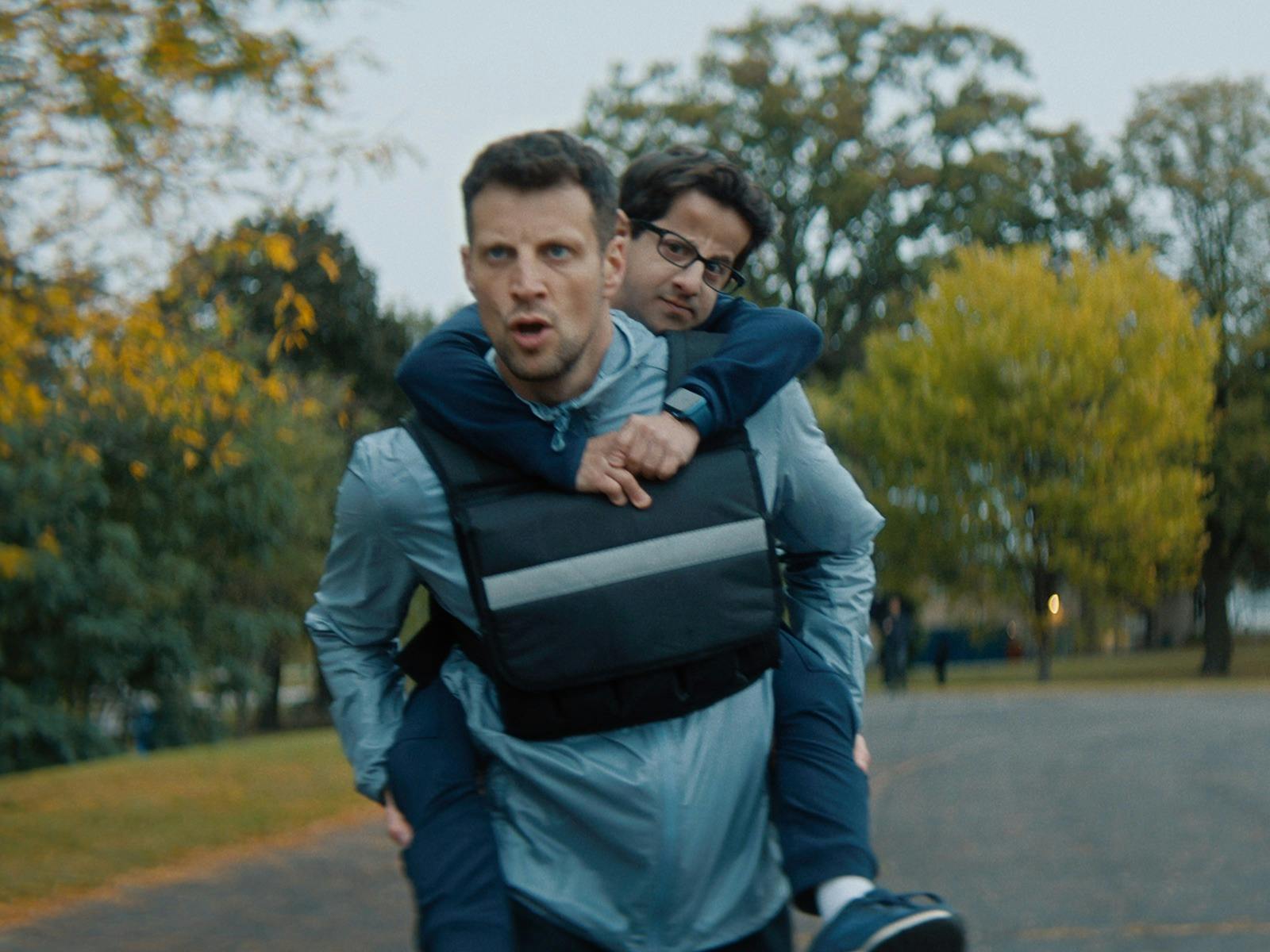 A man runs with another man on his back.