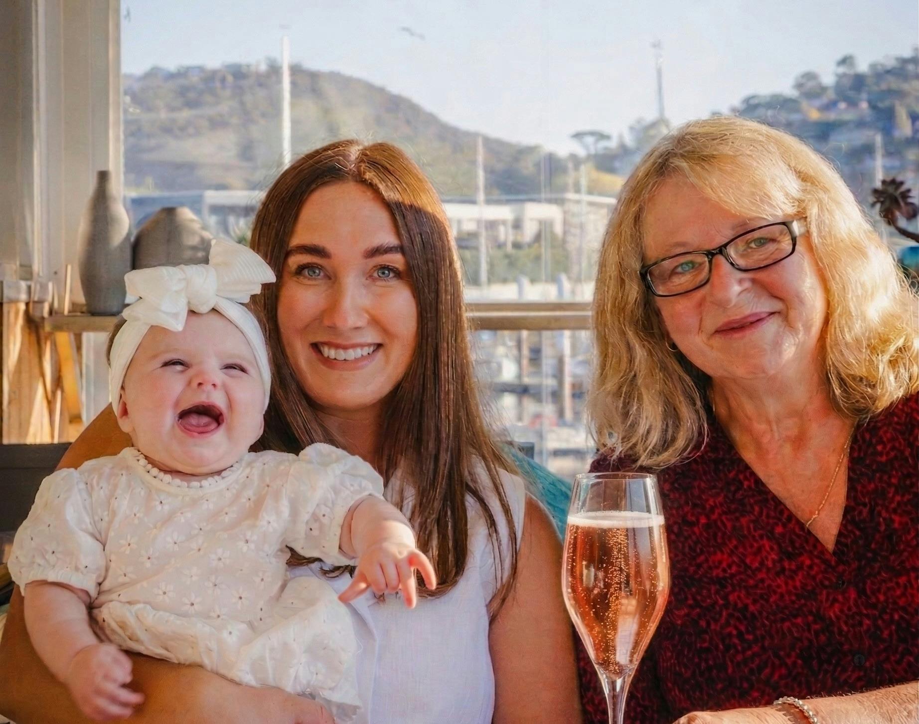 Grandmother with daughter and grandaughter, enjoying a glass of delamere sparkling rose
