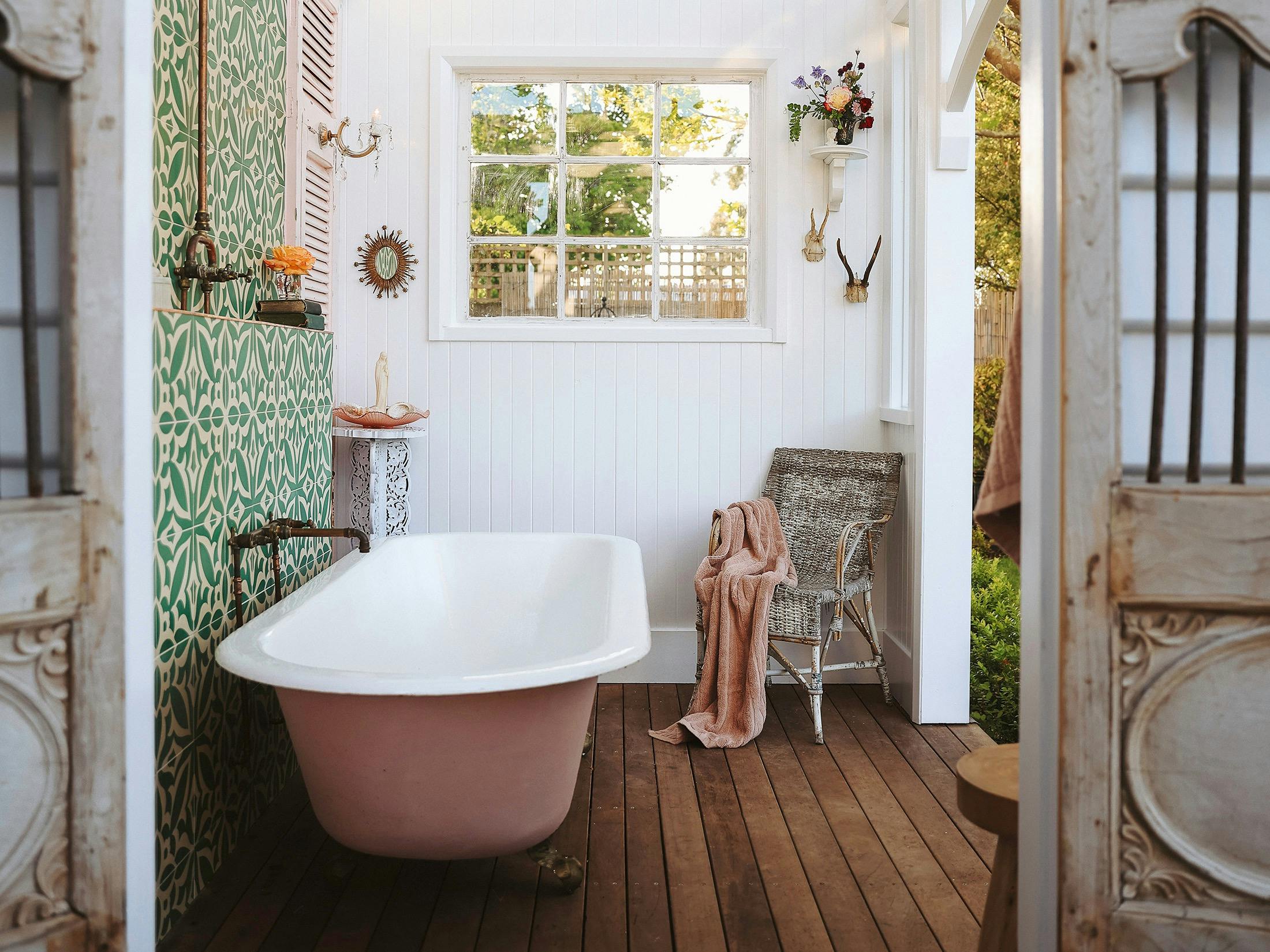 bath house in the garden with a glass ceiling and a  vintage style clawfoot bath tub.