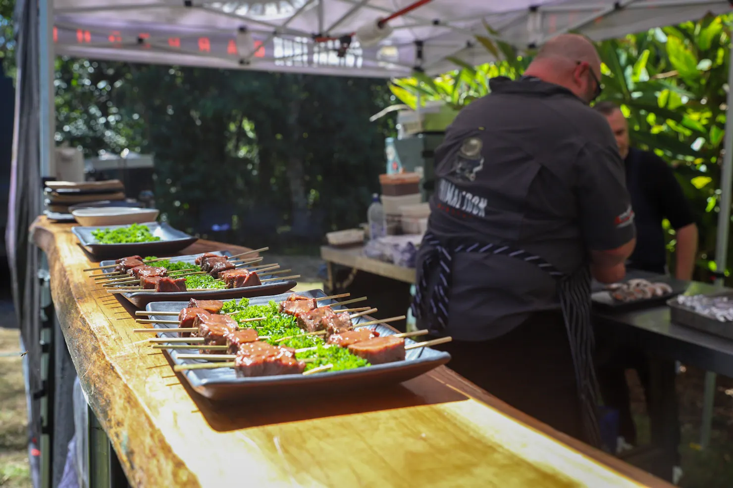 BBQ skewered meat plated on a wooden table
