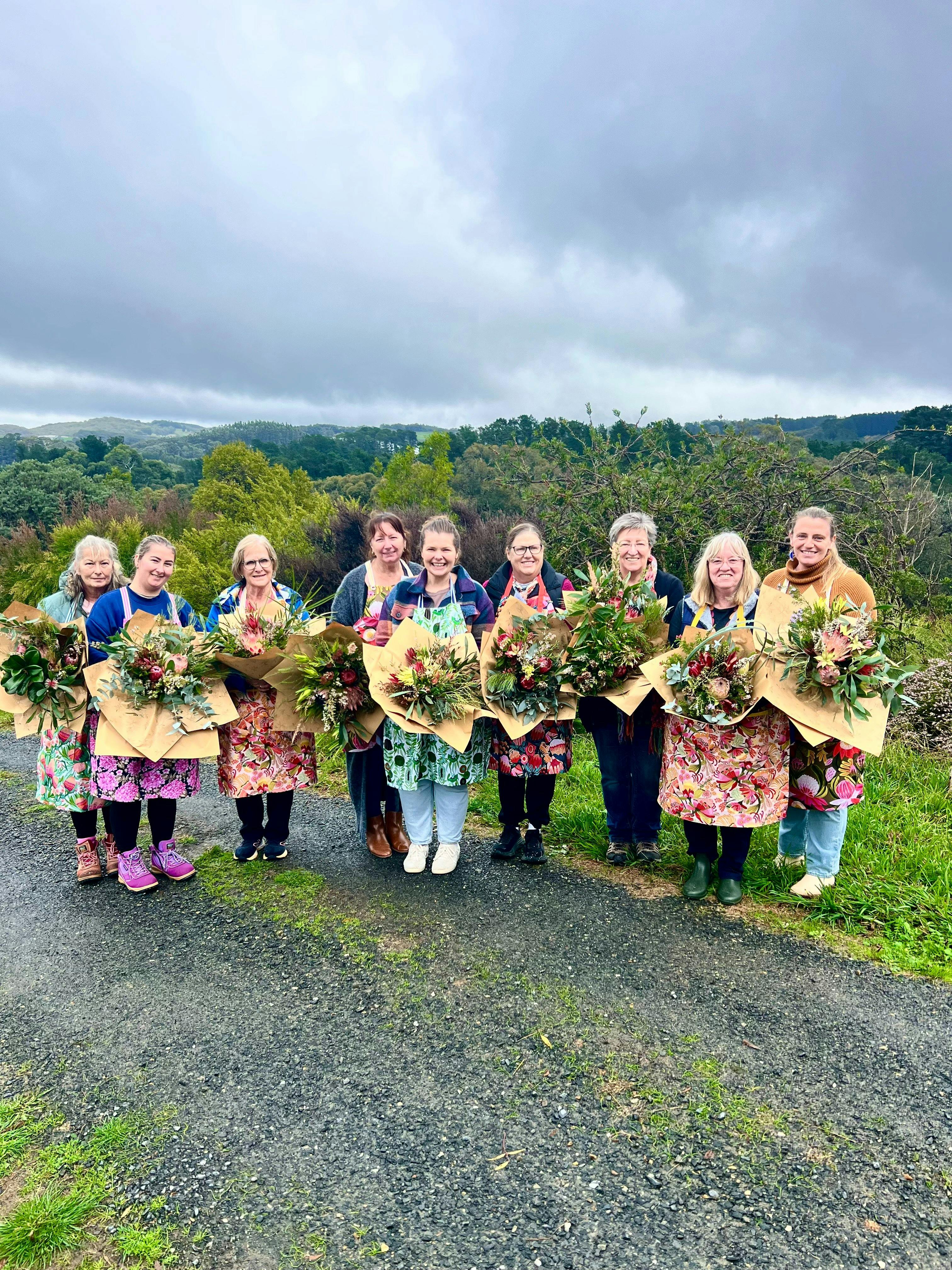 Workshop participants showcasing their unique bouquet creations