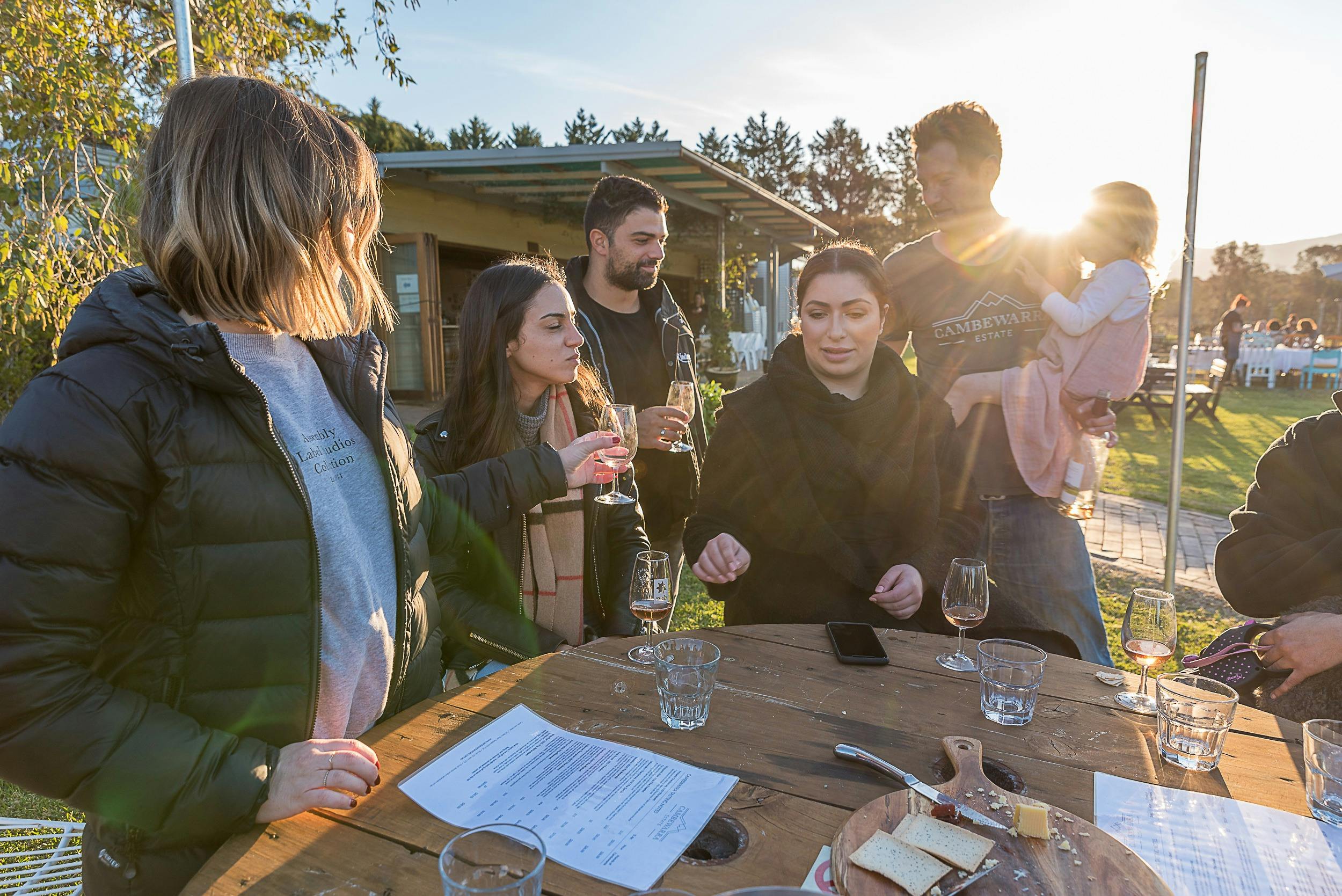 Small group around a table tasting wine and cheese