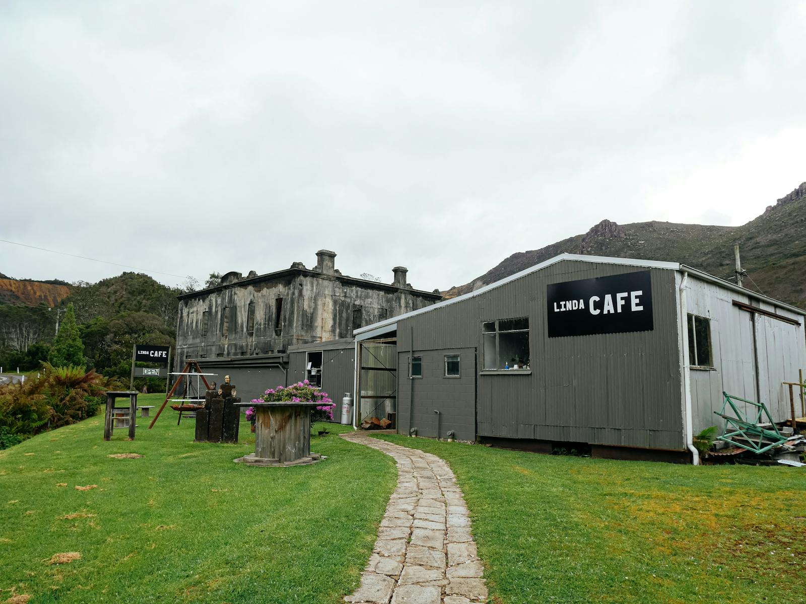 A photo of Linda Cafe from outside on foreground and Royal Hotel in background.