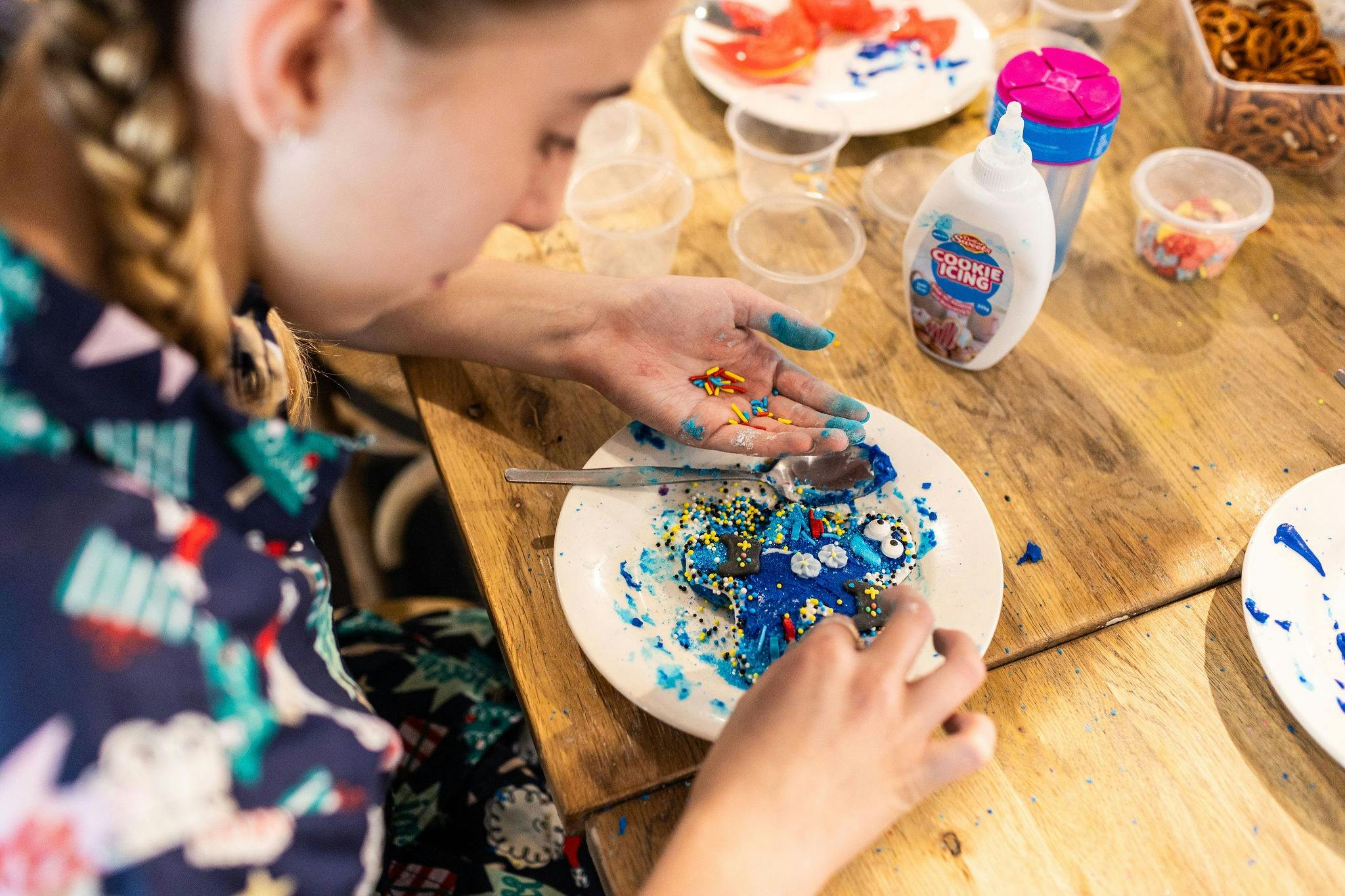 child decorating biscuits