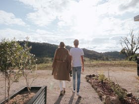 Couple walking hand in hand in the grounds of Kundalini Lodge