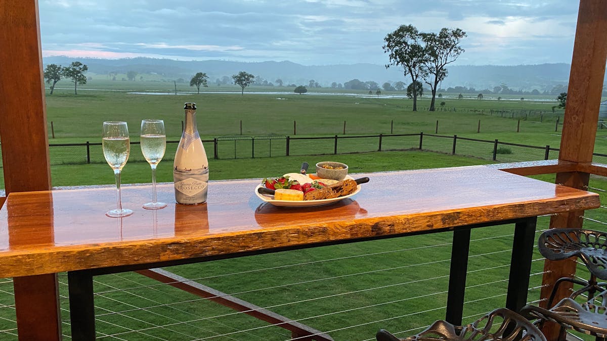 Relax on this spacious deck and enjoy the view overlooking a working beef cattle property.