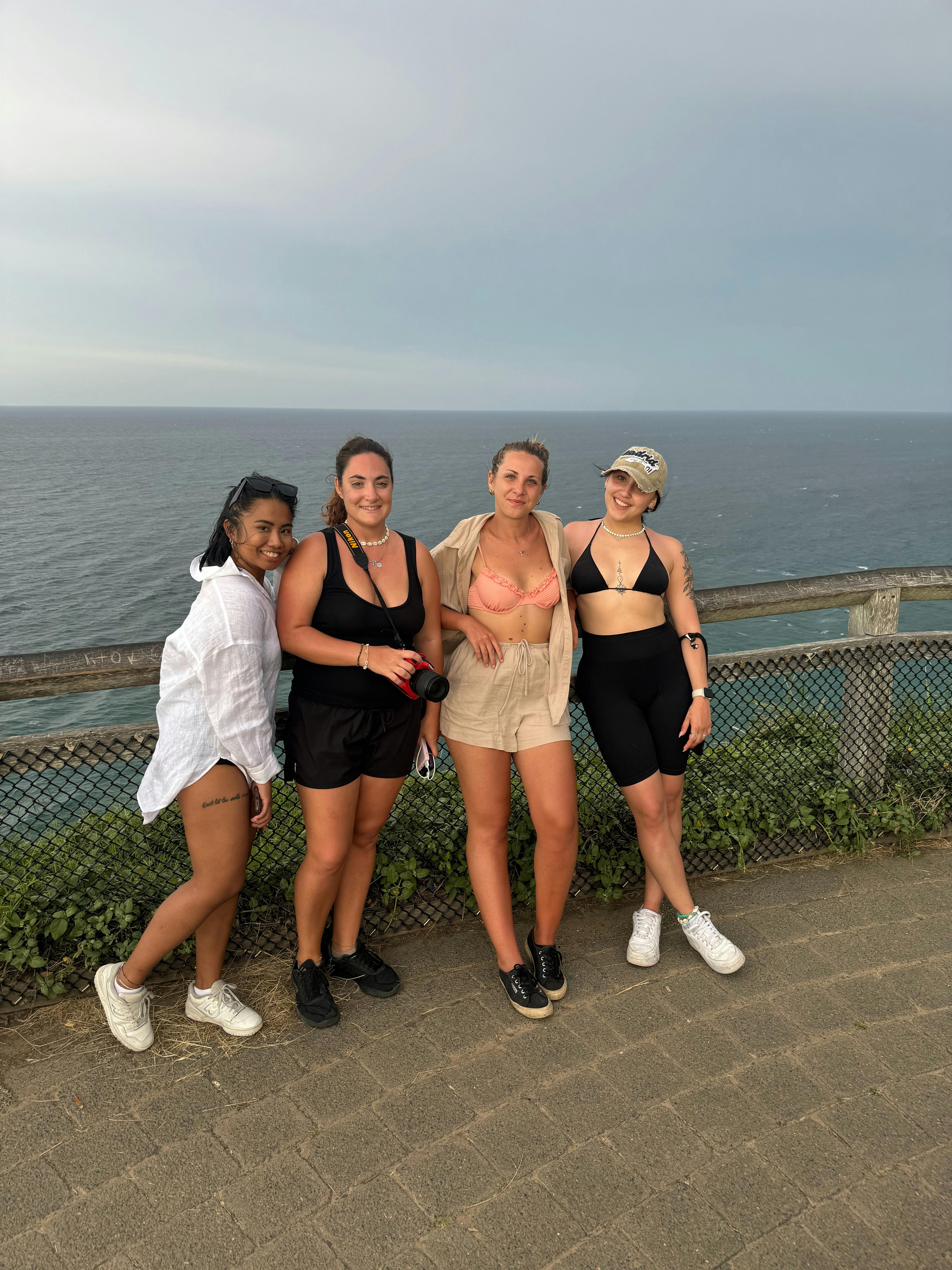 People posing at Cape Byron with the sea in the background