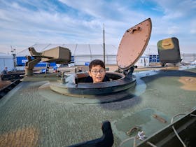Child in a defence tank