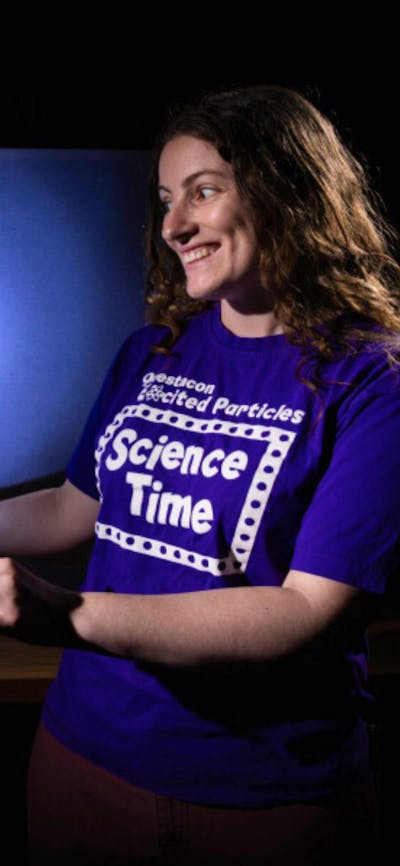 A woman making a dinosaur shadow in Science Time