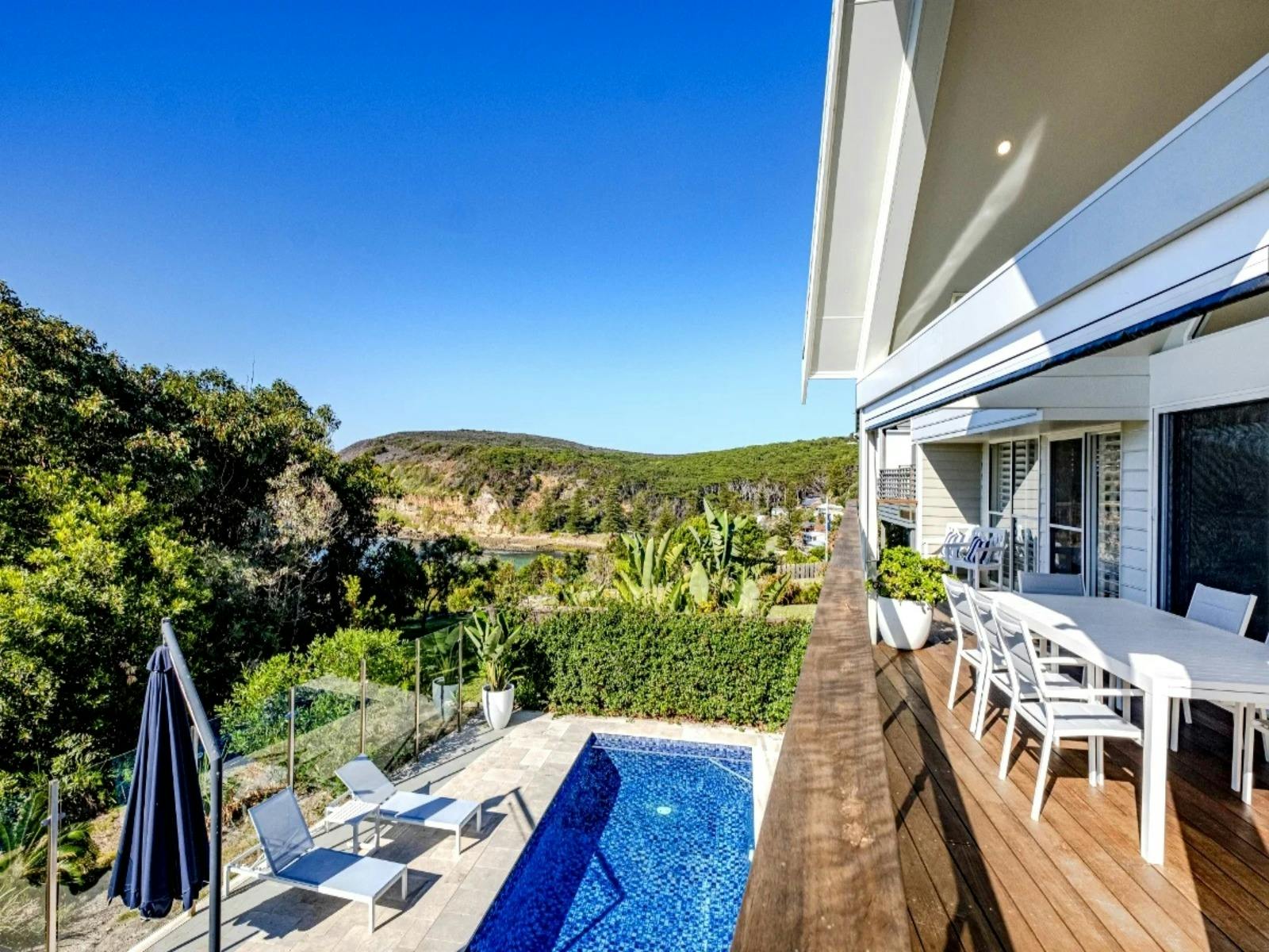 Expansive upstairs balcony featuring an extendable dining table and a gas BBQ