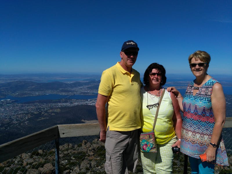 Clients posing on lookout at Mt Wellington summit