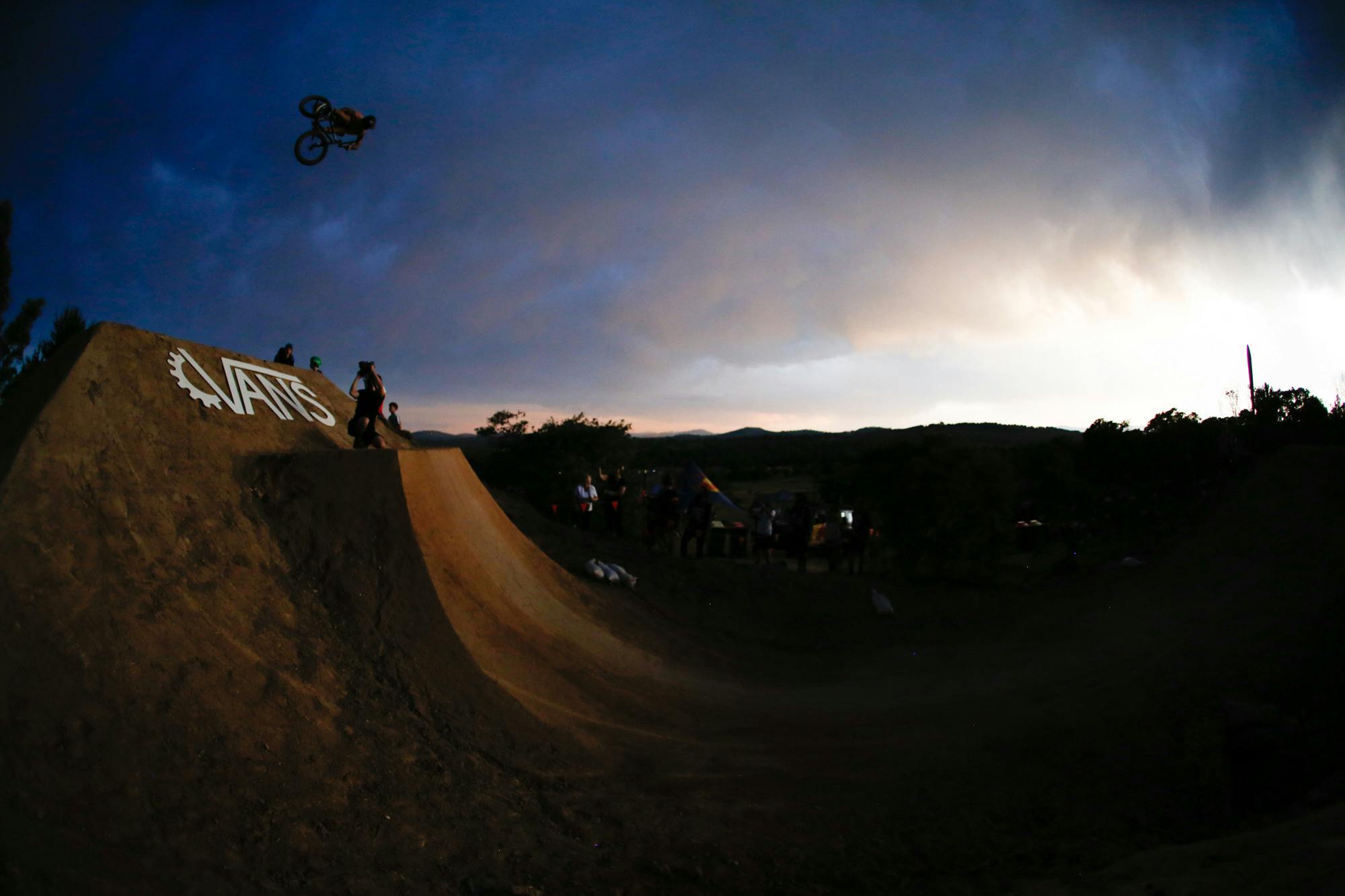 Jason Watts riding a big dirt jump doing a 360 at sunset at Stromlo Forest Park