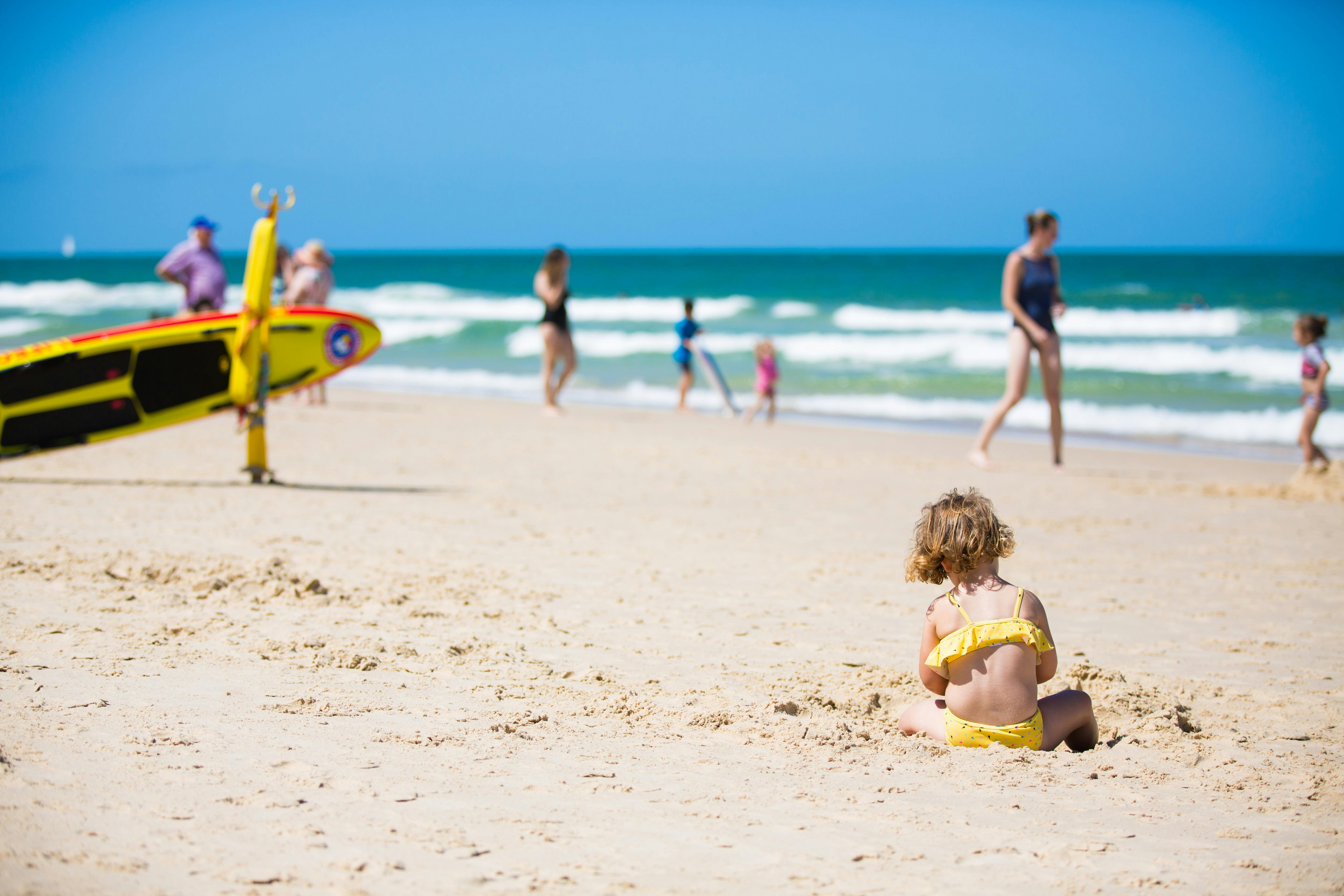 Child playing in sand at Woorim Beach, Bribie Island