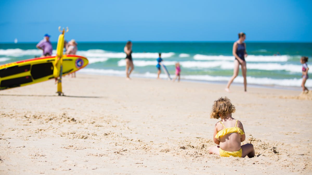 Child playing in sand at Woorim Beach, Bribie Island