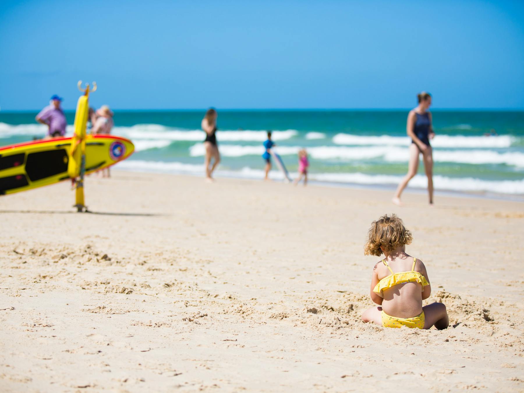 Child playing in sand at Woorim Beach, Bribie Island