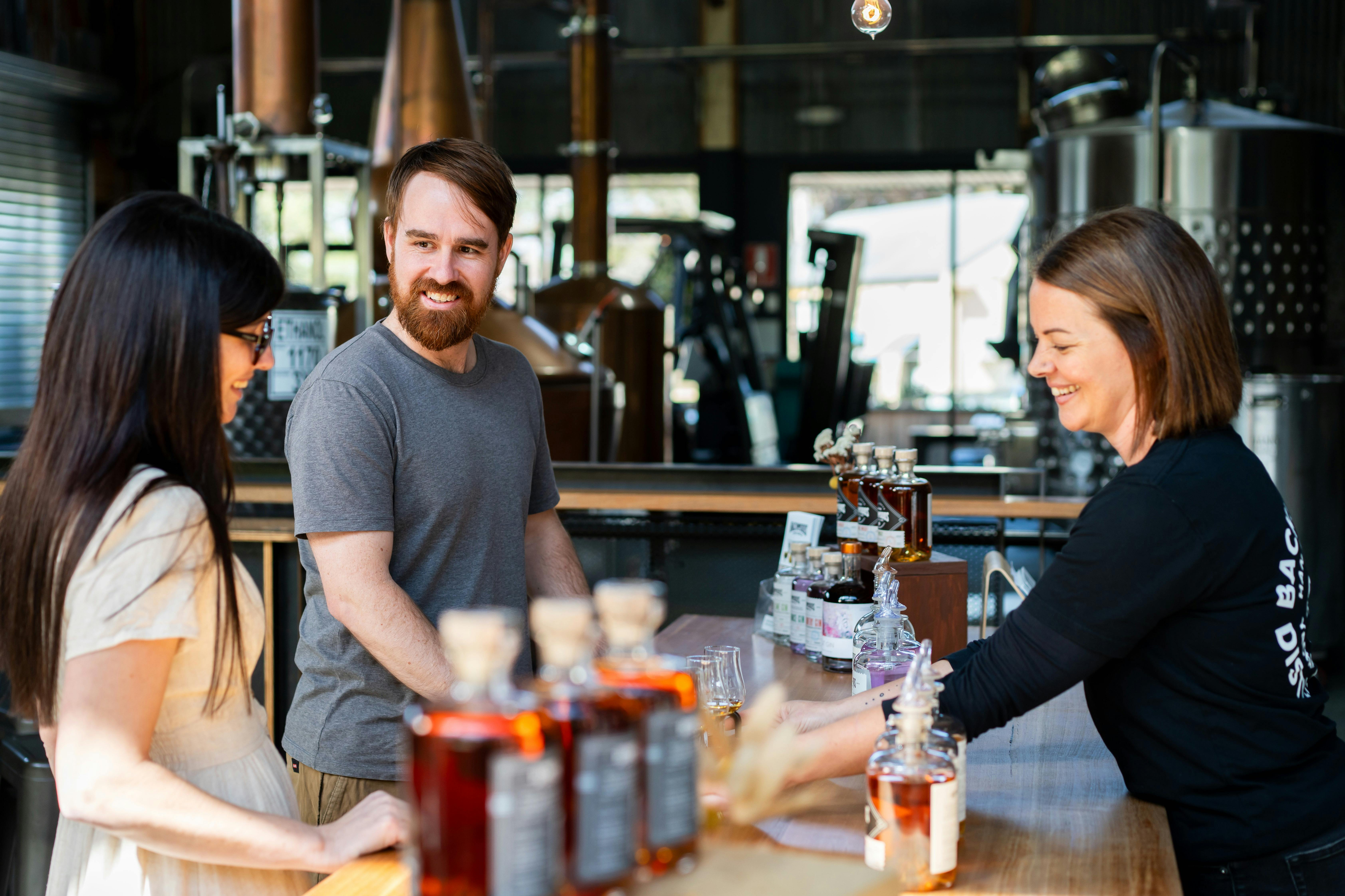 Bree from Backwoods serving customers at the tasting counter