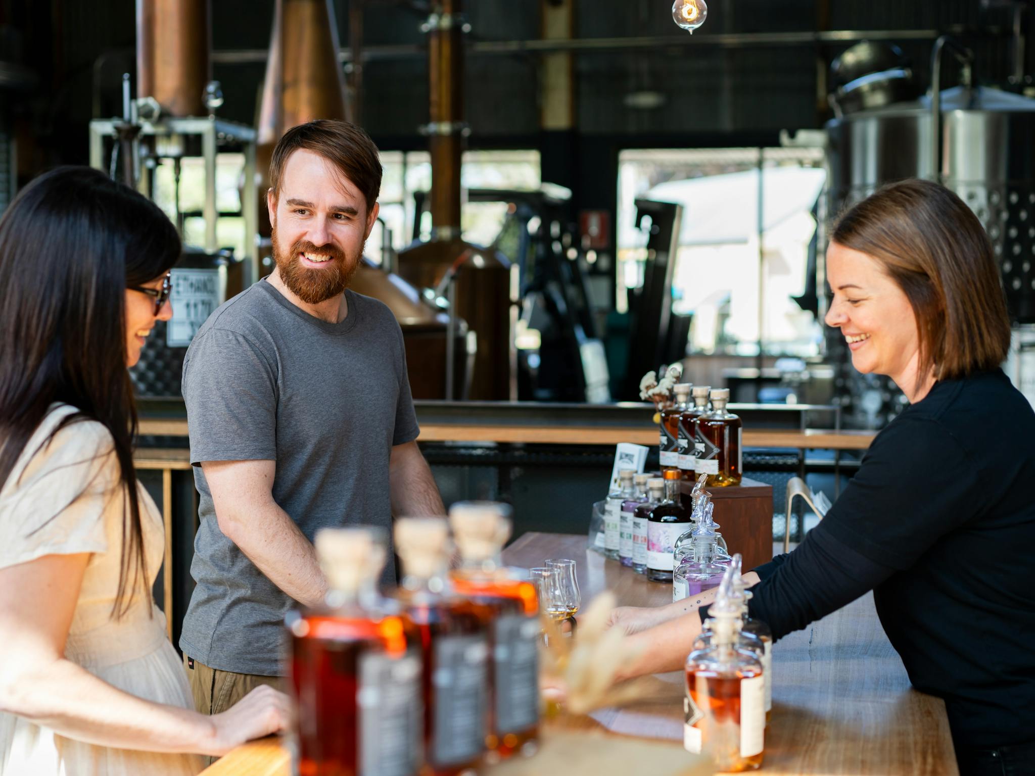 Bree from Backwoods serving customers at the tasting counter
