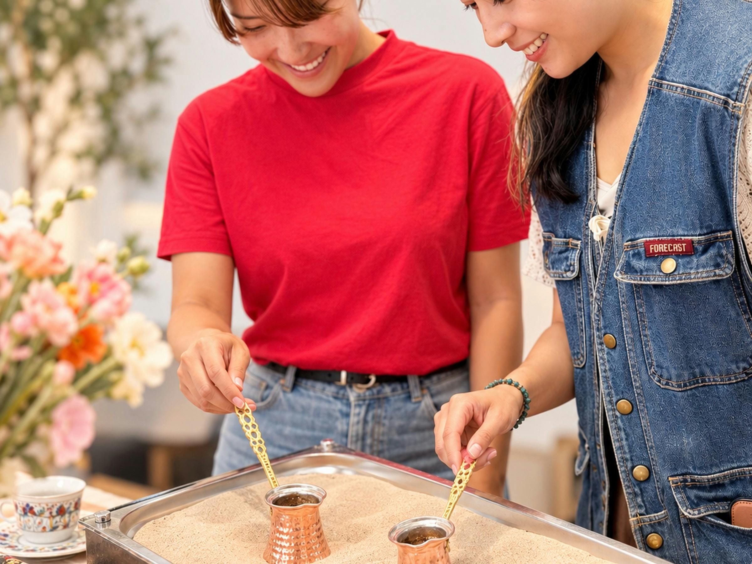 Guests brewing Turkish coffee in copper cezves on hot sand