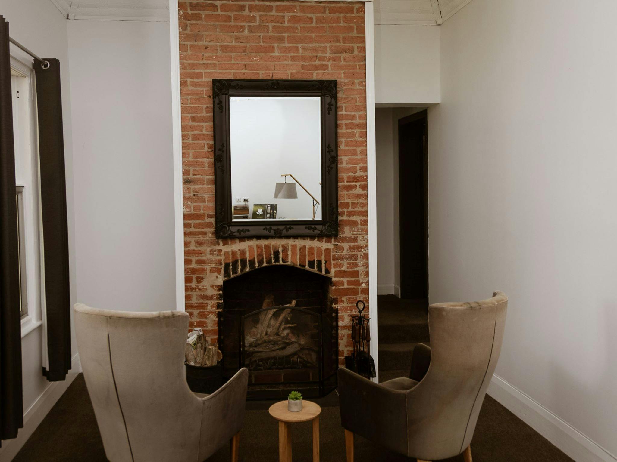 The formal lounge boasts an original open fireplace, a record player and pressed tin ceilings.