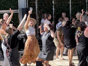 people dancing to music whilst enjoying a glass of wine